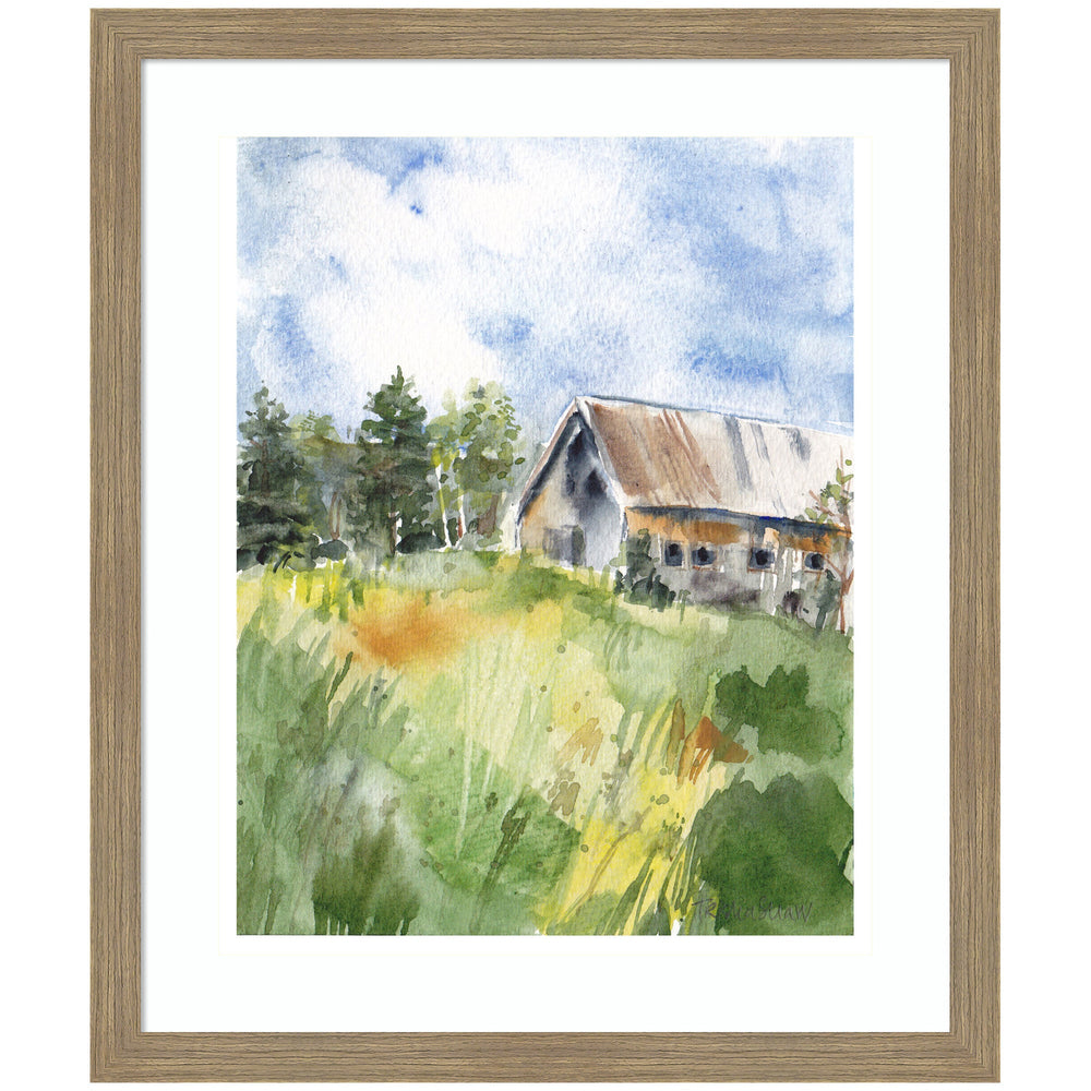 Framed art print of a rustic barn in summer landscape with lush greenery and blue sky