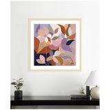 Abstract framed artwork featuring overlapping stylized leaves in warm tones of terracotta, mauve, lavender, and beige on a white wall above a black shelf with plants and books.
