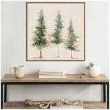 Abstract painting of three evergreen trees in green and blue hues on neutral linen background, framed in wood, hanging above a wood and metal console table with mug, books, and a white vase with greenery.