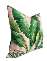 Square pillow cover with large green palm leaves on a light pink background, showcasing detailed leaf veins and natural gradients in green shades.