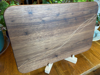 Handcrafted walnut charcuterie board with cherry and maple decorative banding