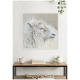 Close-up side profile of a fluffy white sheep with soft wool, captured on a framed canvas print above a wooden console with books and decor.