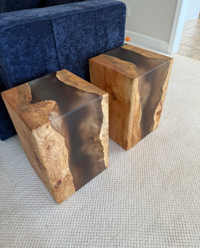 Two wooden side tables with a natural maple finish and epoxy accents on a white background