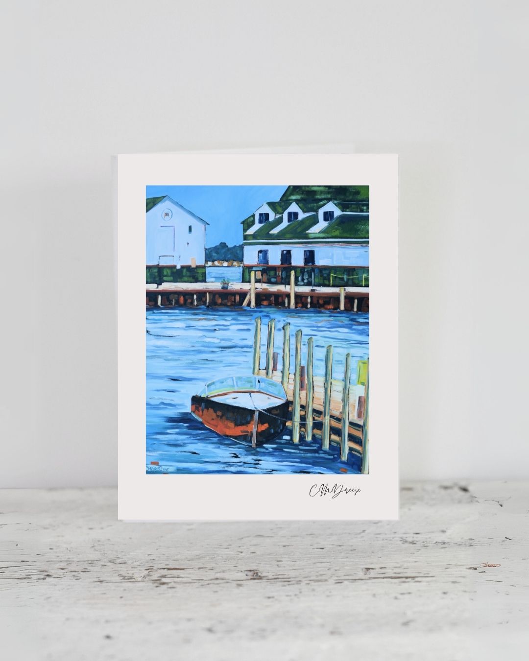 Notecard- Dock Stories on Mackinac Island by Dreese Fine Art showing a clip holding the card with a textured linen surface