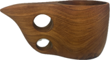 Smooth teak kuksa mug with a curved spout and two round finger holes on its side, showing natural wood grain and warm brown tones.