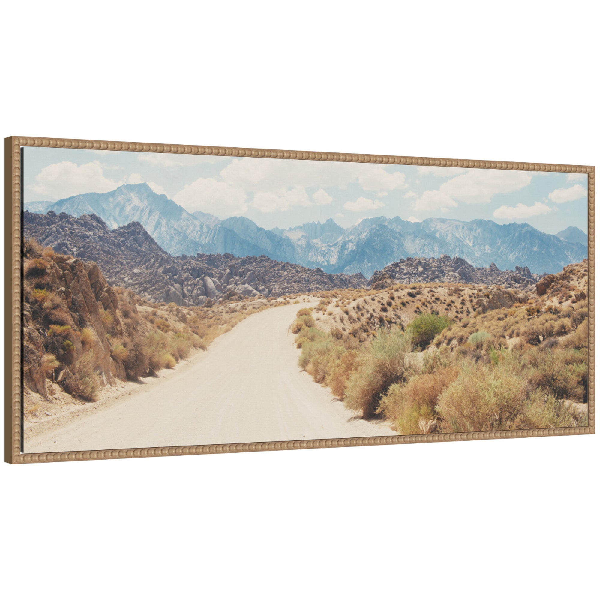 Framed canvas wall art print showing a winding dirt road through desert landscape with mountains and blue sky