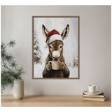Framed canvas showing a donkey wearing a red Santa hat holding a steaming mug, with snowy trees in the blurred winter background.