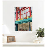 Framed canvas print of a storefront with red window frames, a yellow and green marquee reading 'One Two THREE FOUR,' and a sign below stating 'I Declare A Thumb War'