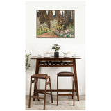 Framed canvas print of John Singer Sargent's 1910 Florence garden painting, hanging above a dark wood bar table with two matching stools and minimal table decor.