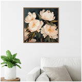 Square framed painting of soft peach and cream floral bouquets with dark green leaves on a deep moody background, hanging above a white couch with gray pillows.