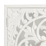 Close-up of a white carved wooden surface featuring intricate floral and leaf patterns with rounded edges and a hinge on the left side.