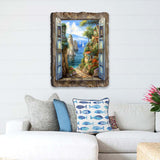 Wall art depicting a coastal village with blue-shuttered window frame, sailboats on blue water, and stone path surrounded by greenery and colorful houses.