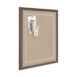 Rectangular beige fabric pinboard with a brown wood frame featuring a white scalloped loop border, displaying two black-and-white pinned photos.