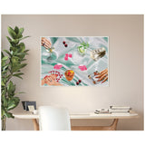 Framed canvas art above desk showing a cocktail party scene with hands holding cards and drinks, pink dice, cherries, rolled dollar bills on a silky pale green background.
