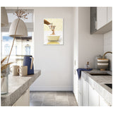 Cozy modern kitchen with light gray stone countertops, white cabinets, and a framed canvas of a mother and baby giraffe in a yellow bathtub on the wall.