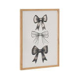 Framed white print featuring three detailed black bows arranged vertically with varying textures and ribbon styles in a light wood frame.