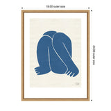 Minimalist abstract nude figure in deep blue, curled with knees and arms visible against a cream background, framed in light wood with white matting.