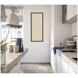 Minimalist kitchen corner with light gray stone countertops, white cabinets, and a narrow framed green lattice print hanging on a white wall between two windows.