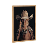 Portrait of a brown horse facing forward, wearing a light brown cowboy hat and a Western saddle against a solid black background.
