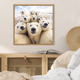 Close-up group of nine polar bears with curious expressions posed together outdoors on snowy ground under a blue sky, framed on a beige wall above a wooden cabinet.