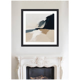 Abstract coastal landscape painting with soft beige sand, muted blue waves, and dark cliff shapes, framed in black above a white ornate fireplace.