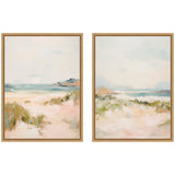 Two framed canvas paintings depicting soft, abstract coastal landscapes with sandy dunes, subtle greenery, and calm sea under pale sky tones.