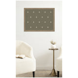 Olive green botanical block print with small white floral motifs evenly spaced in a walnut-colored frame, displayed above a minimalist side table and cream chairs.