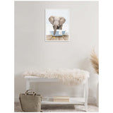 Framed canvas of an elephant standing inside a blue clawfoot bathtub with a white towel, hung above a white bench draped with a cream fur throw in a neutral room.