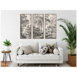 Three-panel black and white landscape canvas art featuring detailed trees above a white couch with patterned pillows, flanked by green plants in modern pots.