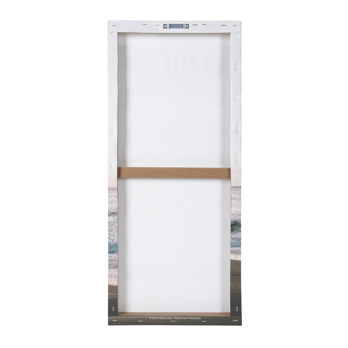 Back view of a rectangular canvas stretched over a wooden frame, showing white fabric and a horizontal wooden support bar in the center.