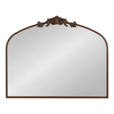 Rectangular wall mirror with a rounded top and a dark wood frame, featuring an ornate carved floral design centered at the arch's peak.