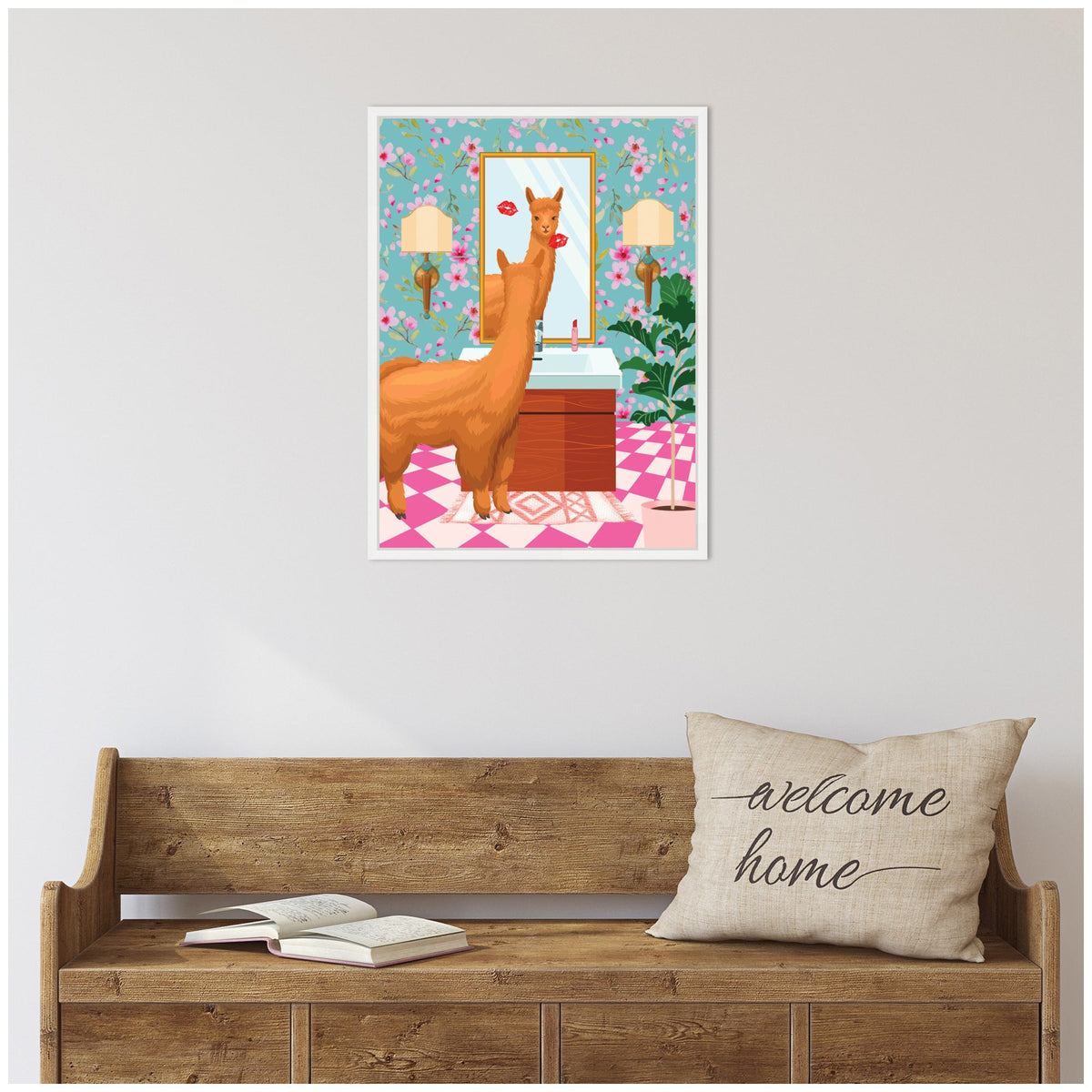 Illustration of a light brown llama standing in a pink and white tiled bathroom with floral wallpaper, a wooden vanity, wall sconces, and a mirror showing red lipstick marks.