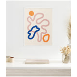 Abstract line art print with curving blush pink pathways, a bold cobalt blue irregular shape, and two orange rounded forms on a beige textured background in a white frame.
