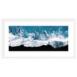 Framed minimalist art print showing aerial view of ocean waves crashing on a black beach in Iceland by Michael Schauer