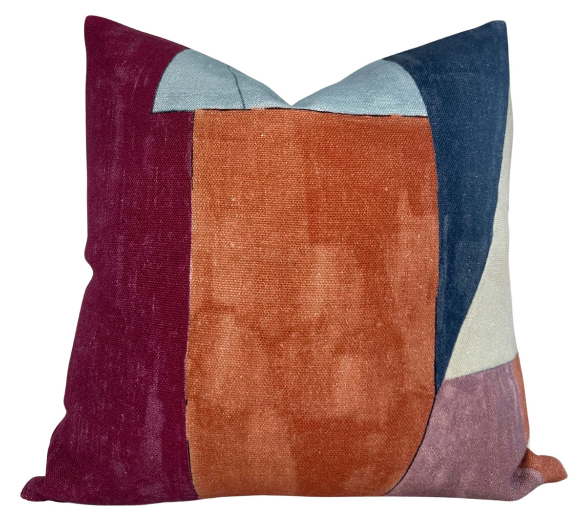 Square pillow featuring color-block design with claret red, rust orange, navy blue, light blue, cream, and mauve fabric sections