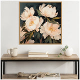 Framed canvas painting of four large white peony flowers with green leaves on a dark background, hung above a wooden console with neutral decor.