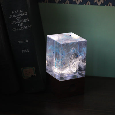 Handcrafted resin table lamp with ocean-inspired colors and warm white LED light