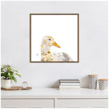 Framed canvas art of a duck's head and neck in profile with textured, yellow and white feathers against a white background, hanging above a white dresser with plants and decor.