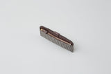 Slim zippered long wallet with gray and white zigzag pattern and brown leather interior, shown partially open against a plain white background.
