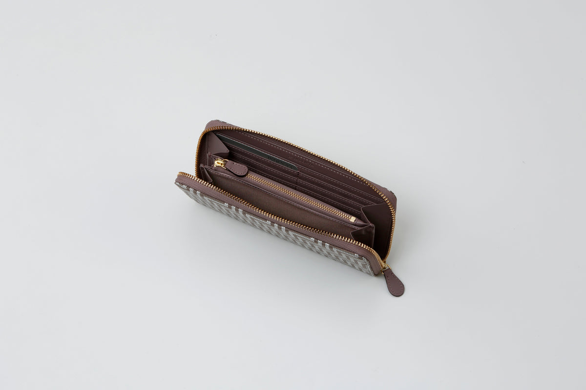 Open zipped long wallet in brown tones with multiple card slots and a central zippered coin compartment, shown from above against a plain light background.
