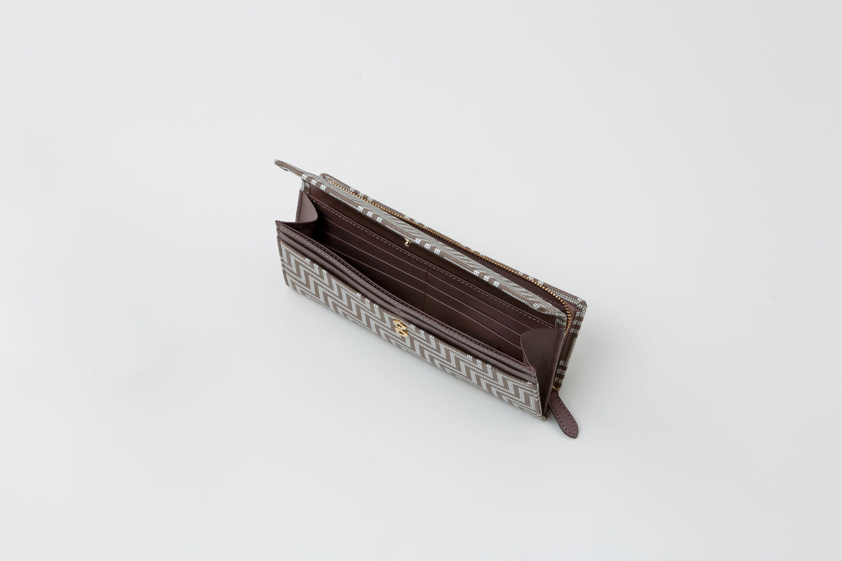 Open long wallet with brown leather interior and exterior patterned with white and beige chevron stripes, displayed on a white background.