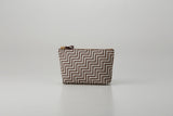 Rounded trapezoid brown deer skin pouch with white hand-drawn pattern and gray lacquered dots