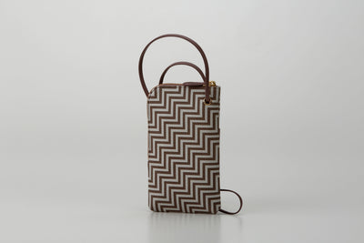 New Grecian leather phone case with white hand-drawn pattern and gray lacquer dots, equipped with detachable strap.