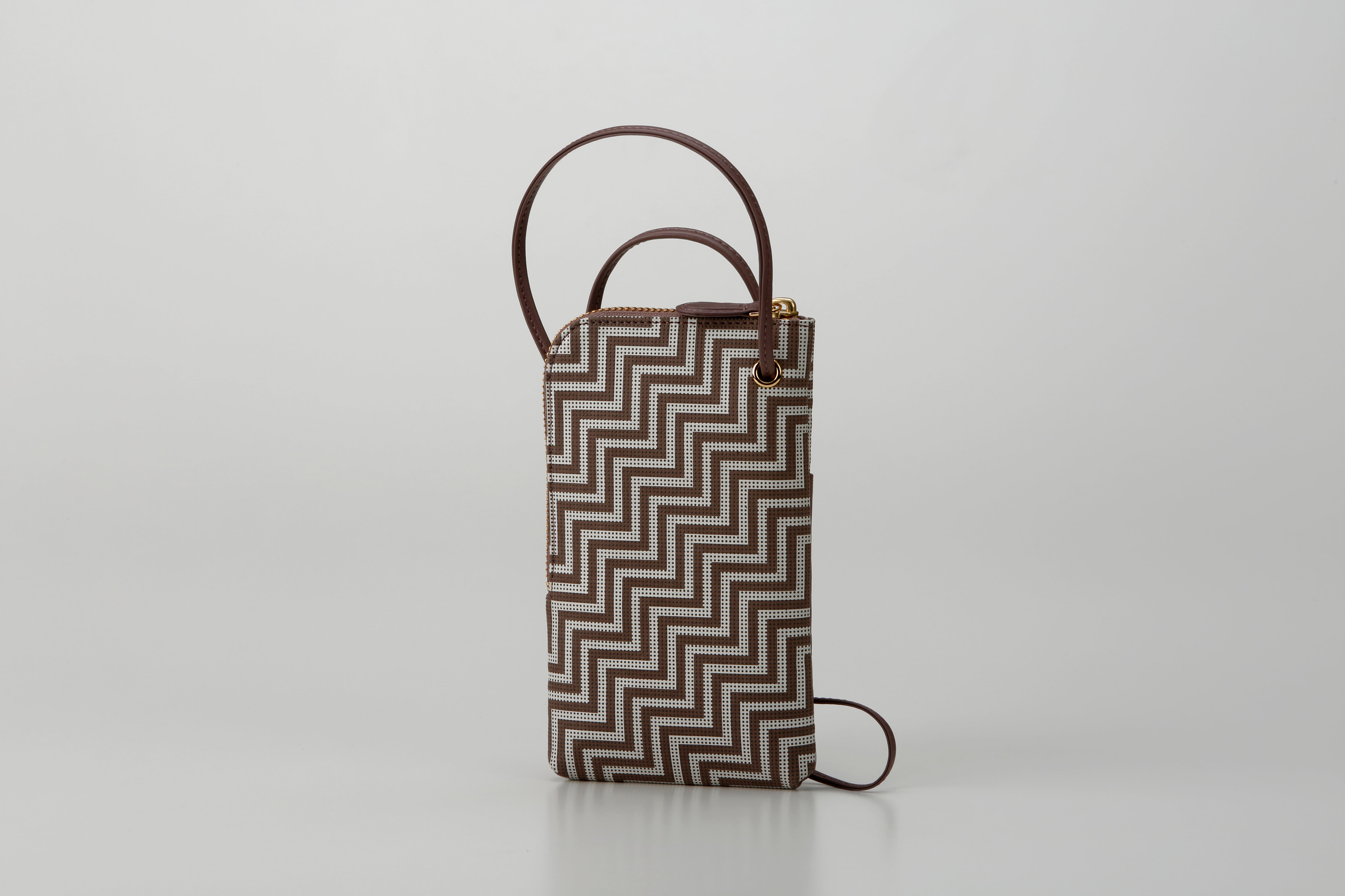 New Grecian leather phone case with white hand-drawn pattern and gray lacquer dots, equipped with detachable strap.