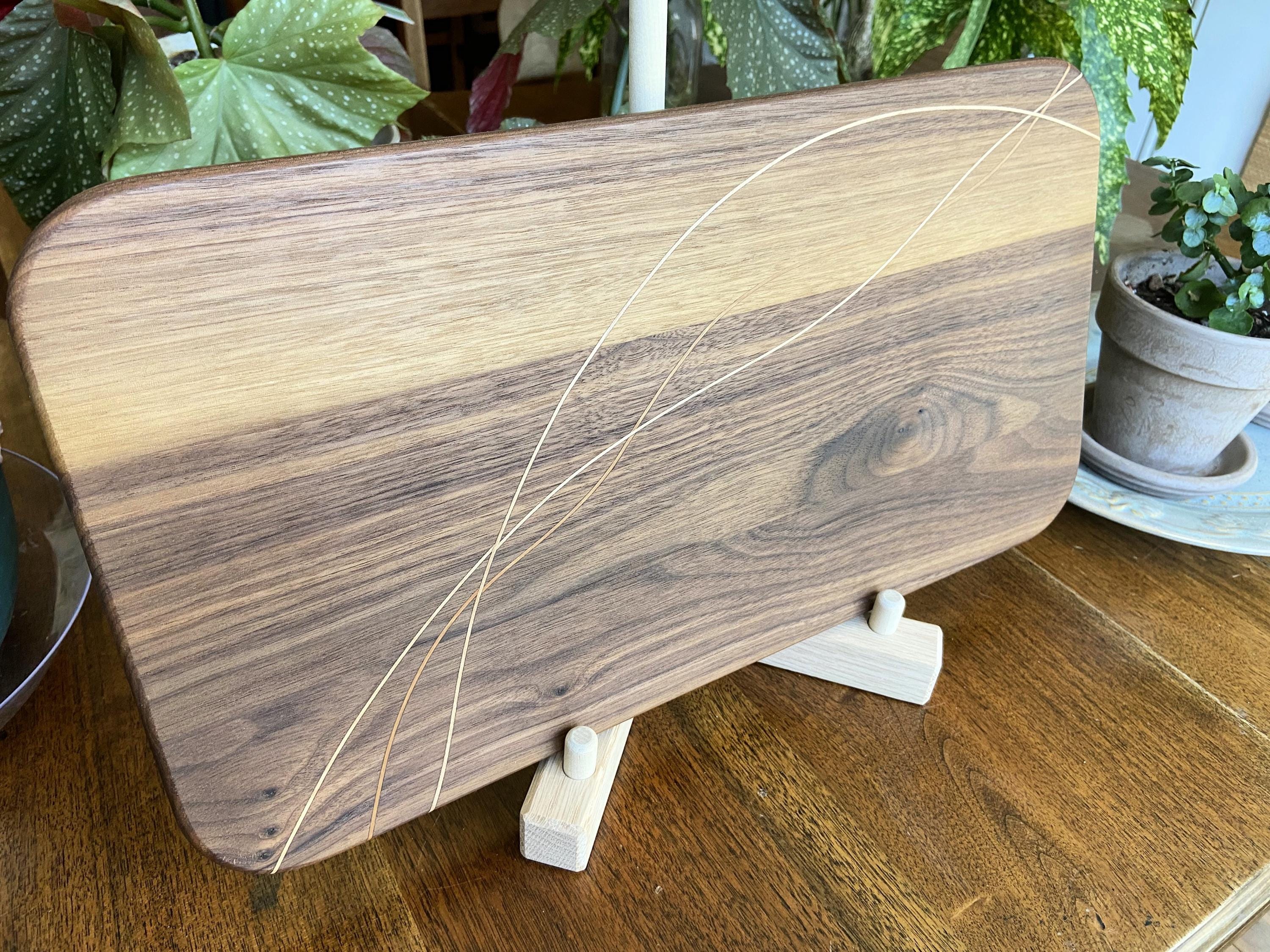 Walnut charcuterie board with cherry and maple decorative banding, handcrafted serving board