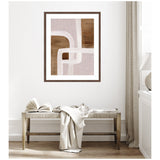 Abstract framed artwork featuring intersecting rhythmic lines in muted brown and beige tones hung above a woven bench with a draped cloth in a minimal room corner.