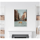 Framed canvas of a tiger crossing an empty urban street surrounded by tall buildings, mounted above a white fireplace in a bright room with shelves and wicker baskets.