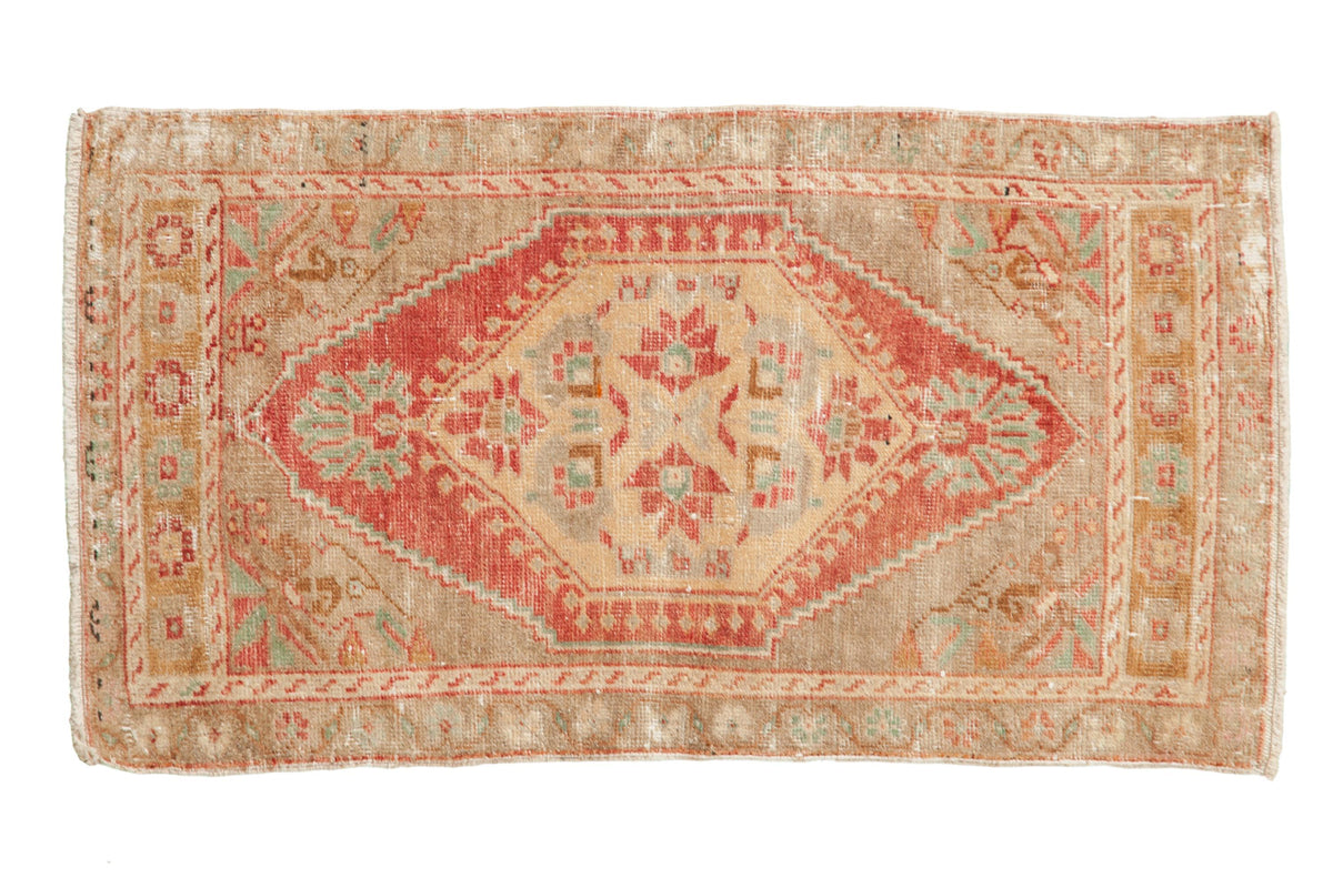 Vintage distressed Oushak rug mat runner with hexagonal center medallion and floral palmette design in reds, beige, and turquoise