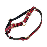 Harness made of red Italian leather with black leopard print and gold-tone metal buckles and rings, shown on a white background.