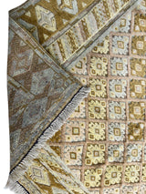 Hand-knotted Afghani Nakhunak wool rug with a geometric diamond pattern in muted yellow, beige, and brown tones, showing both front and fringed back corners.